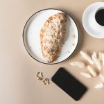 Coffee, scone, earrings, and cell phone